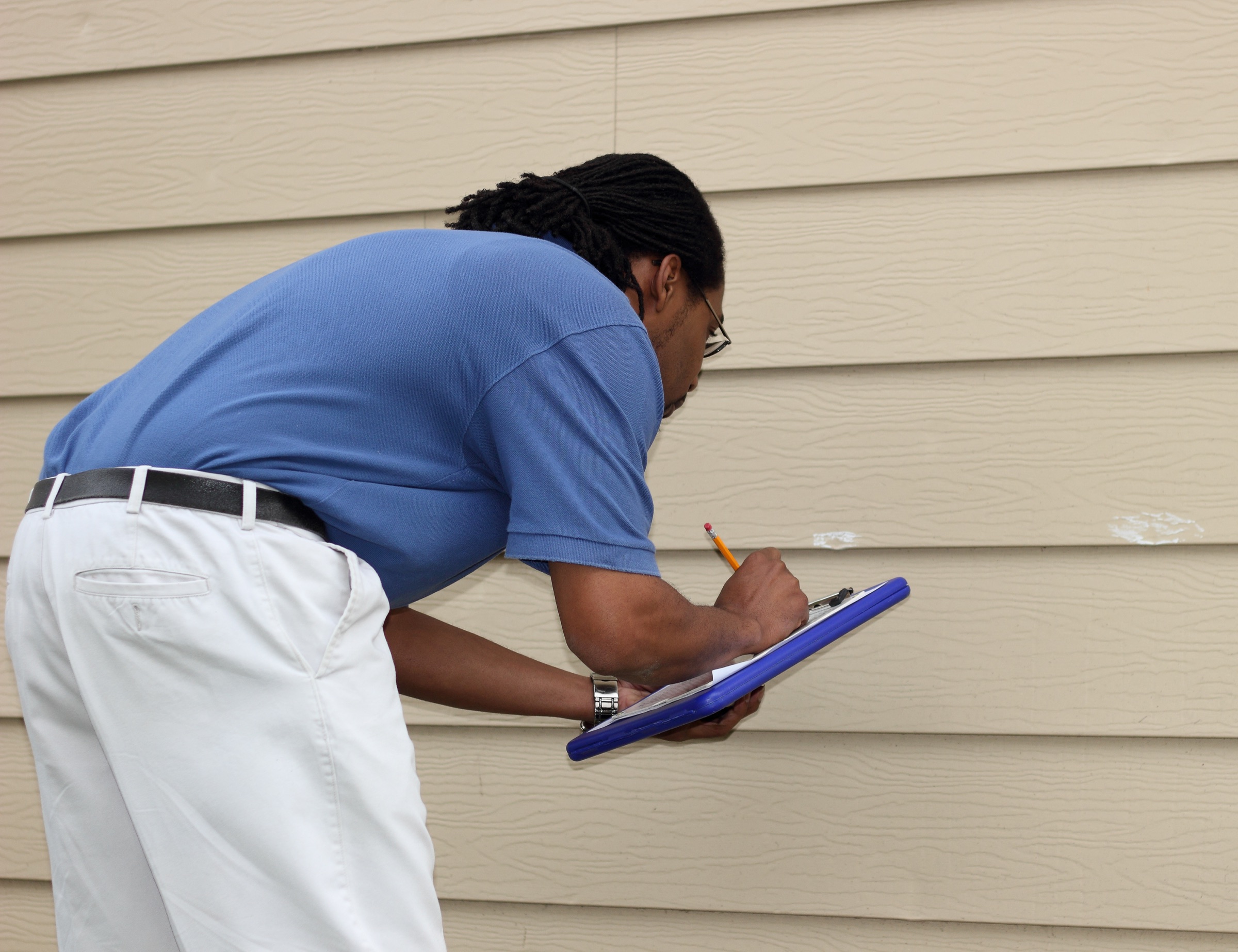 Field adjuster documenting exterior property conditions